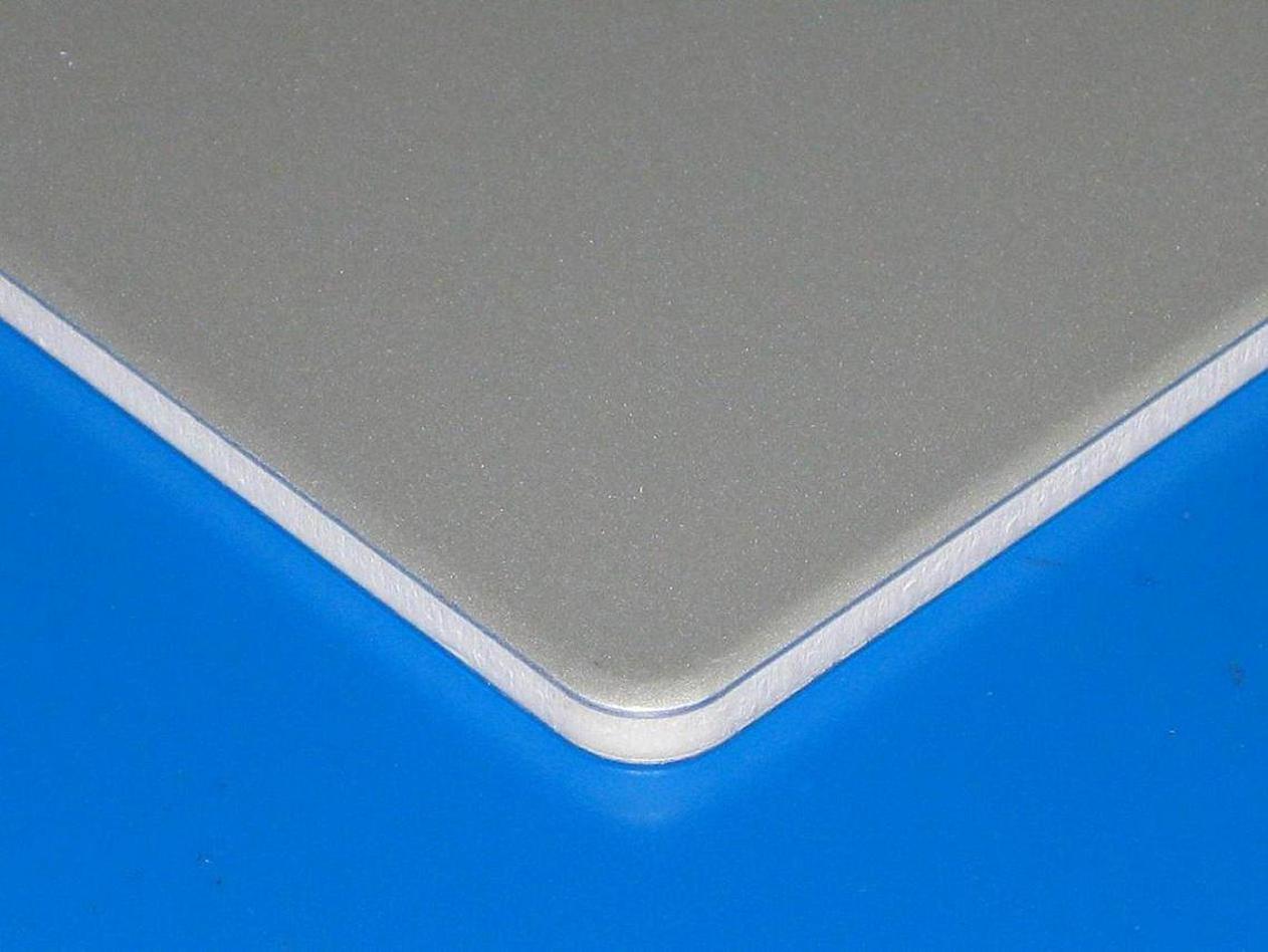 Aluminum composite panel sample showing a light-colored core at the edge